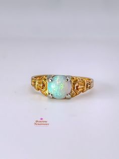 Item Description: This exquisite opal ring is a true gem from the Antique Edwardian/Art Deco period. Crafted in 14K yellow gold with intricate carved detailing on the band, this ring showcases a stunning pale blue opal with captivating red undertones when exposed to light. The single stone opal is cut in a cabochon style, measuring approximately 7mm in width, 7mm in length, and 4mm in depth. The band width is a delicate 1mm at its shortest. Don't miss the opportunity to own a piece of history with this timeless and elegant opal ring. Key Information: - Category: Fine Jewelry - Era: Antique Edwardian/Art Deco Period - Metal: 14K Yellow Gold with White Gold Prongs - Stone: Opal - Stone Shape: Cabochon - Stone Color: Pale Blue with Red Undertones - Size: Approximately 6.5 - Measurements: 7mm Antique Opal Ring, Edwardian Ring, Edwardian Art, Romantic Jewellery, Cabochon Ring, Single Stone, 14k Gold Ring, Opal Ring, Antique Jewellery