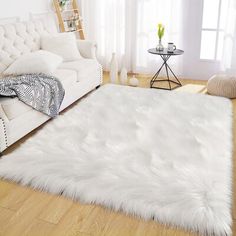 a living room with a white couch and rug