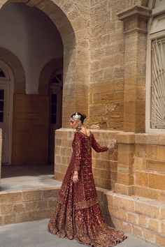 Pakistani Bridal Dress in Red Lehenga and Kameez Style is embellished with the hand-crafted details of zardosi, dabka, and motifs. Perfect stitching and premium quality fabric make this Lehenga Dress an epitome of beauty and your foremost priority for the wedding. Lehenga Kameez: The stunning kameez in an alluring red color is beautifully embellished with the intricate zardosi, dabka, resham french knots, threads, motifs, dabka, naqshi, zari, and sequins. Premium quality khaadi net fabric, kamdaani work, and perfect stitching make this Pakistani Bridal Dress a perfect choice to have a gorgeous wedding look. Red Lehenga: The embellished kameez is paired with Bridal Lehenga, creating a lavish Pakistani Bridal Outfit. The Farshi Lehenga has an alluring red shade and is gracefully emblazoned w Traditional Anarkali Set With Hand Embellished Drape, Traditional Hand Embellished Anarkali Set With Drape, Traditional Hand Embellished Anarkali Set, Traditional Floor-length Hand Embellished Salwar Kameez, Traditional Hand Embellished Floor-length Salwar Kameez, Red Dabka Lehenga For Reception, Traditional Hand Embellished Gown For Eid, Traditional Eid Anarkali Set Hand Embellished, Traditional Hand Embellished Lehenga For Eid