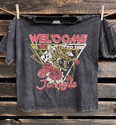 Country Deep Welcome to the Jungle Vintage relaxed fit cotton T-Shirt. available in Acid mineral wash black This relaxed fit Crew neck T-shirt is wider than a normal Tee for a more relax flowy fit. It's mineral washed to look and feel just like your favorite vintage T shirt .Hemmed at the bottom Made from 100% ringspun cotton, the fabric is substantial but washed down and exceptionally soft. Broken in for a lifetime of comfort and wear in vintage black SIZING Small-Width 20 inches --Length botto Welcome To The Jungle Shirt, Trendy Stonewashed T-shirt For Summer, Edgy Washed Black T-shirt For Spring, Spring Crew Neck Stonewashed T-shirt, Summer Black Washed T-shirt, Black Washed T-shirt For Summer, Summer Tops In Washed Black With Letter Print, Trendy Stonewashed Short Sleeve T-shirt, Summer Washed Black Tops With Letter Print