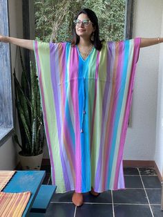 This is our "Timeless" style kaftan. It features a drawstring that you can cinch at the waist. This loose fitting Caftan House dress is exceptionally comfortable and stylish.As for the fabric pattern, we have used a hand drawn and digitally painted technique. So they are all unique designs. It is like wearing wearable art. What I love about digital paintings is that they look as beautiful as the hand paintings but the care needed for them is much less. You can wash them on a gentle cycle and han Vacation V-neck Kaftan With Tassel Ties, Long Multicolor Kaftan For Loungewear, Bohemian Dress With Drawstring, Bohemian V-neck Kaftan With Tie Waist, Bohemian Multicolor Maxi Dress With Tie Waist, Multicolor Bohemian Maxi Dress With Tie Waist, Bohemian Drawstring Dress For Vacation, Bohemian Flowy Maxi Dress With Drawstring, Bohemian Beach Dress With Tie Waist