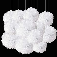 a bunch of white fluffy balls hanging from strings on a black background with the words,'what is that? '