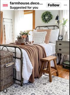 a bed room with a neatly made bed and baskets on the nightstands next to it