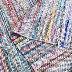 multicolored crocheted rugs laid out on top of each other