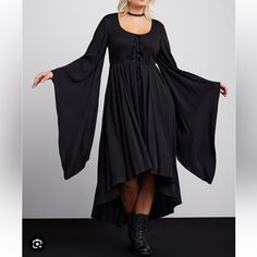 Nwt New In Package Torrid Plus Size Halloween Collection Size 2 2x 18-20 This Costume-Dress Screams Spooktacular With Its Exaggerated Hi-Lo Hem, Voluminous Bell Sleeves, And Lace-Up Front. Make This All Hallows Eve One To Remember, And One That Will Turn Heads (Maybe All The Way Around)! Stretch Challis Woven Fabric Scoop Neck; Lace-Up Front Extra-Long Bell Sleeves Front Pockets Maxi Hi-Lo Hem Content + Care Rayon/Spandex Wash Cold; Dry Low Imported Plus Size Costume Dresses #Halloween #Cosplay Black Witchy Dress For Fall, Witchy Black Dress For Fall, Witchy Fall Dresses, Plus Size Alternative Fashion, Halloween Oc, Laceup Dress, Victorian Gothic Style, Purple Corset, Witch Style