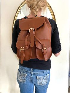 "Backpack bag, brown faux leather backpack,Converts to shoulder bag, mint condition, Whiskey brown Top loop handle for carrying Flap over and Snap clasp closure. 2 front snap close pockets PLEASE SEE MEASUREMENTS Measures: 12\" tall x 10\" x 5.5\" deep Straps: adjustable Should strap drop is 12\" NK216B3 Backpack bag, brown faux leather backpack,Converts to shoulder bag, mint condition, Whiskey brown" Vintage Leather Backpack With Adjustable Strap For School, Brown Satchel With Large Capacity, Casual Faux Leather Backpack For School, Brown Softback Satchel With Large Capacity, Casual Faux Leather School Backpack, Trendy Brown Leather Backpack For School, Trendy Brown Leather Satchel Backpack, Casual Leather Satchel For Students, Trendy Brown Leather School Backpack