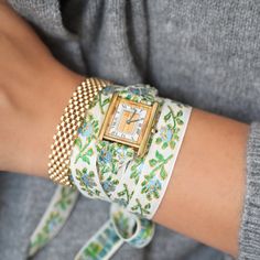 Our 2nd and Final Garden Party Vintage Wrap Watch features a vintage Must De Cartier Tank Quartz Watch circa the 1990s, reimagined with a feminine brocade ribbon designed to be wrapped multiple times around the wrist and tied off for a truly one of a kind look. This watch comes with both the blue/green ribbon AND the black/pink ribbon. Sterling Silver base with gold plating. Highly unique mixed metal Trinity Dial. Quartz Movement. Sold as is, plating has wear on the dial that adds to the piece's Vintage Fine Jewelry, Cartier Tank, The 1990s, Ribbon Design, Green Ribbon, Curated Vintage, Wrap Watch, Pink Ribbon, Estate Jewelry