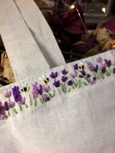 a white bag with purple and yellow flowers on it