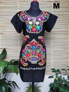 Beautiful dress embroidered with bright colors by artisans from the state of Oaxaca, to pour on any occasion. This dress has straps to adjust at the back. Each dress has a unique embroidery, so colors may vary. The short sleeveless and embroidered dresses hand, they are also beautiful, unique pieces. Mexican textile art has centuries of history and creativity throughout the country. Mexico is recognized as one of the leading countries with a beautiful artistic production in the textile world, mi Multicolor Folk Dress With Floral Print, Traditional Black Dress With Floral Print, Traditional Embroidered Beach Dress With Embroidered Hem, Traditional Embroidered Dress For Beach With Embroidered Hem, Traditional Floral Embroidered Dress For Vacation, Traditional Black Floral Print Dress, Multicolor Embroidered Tunic Dress For Festivals, Bohemian Embroidered Festival Dresses, Bohemian Embroidered Dress With Multicolor Hem