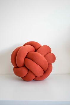 an orange ball sitting on top of a white table