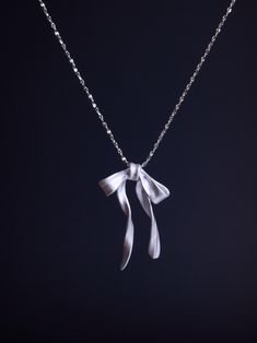 This Sterling Silver Bow Necklace is a dainty, handmade piece crafted from 925 Sterling Silver. With its elegant ribbon design, it's the perfect minimalist everyday necklace or a thoughtful gift for her. ☘️ Necklace length: 16 inches ☘️ Other Considerations: - Comfort Assured: My handmade jewelry is nickel-free and hypoallergenic, making it safe and comfortable for all skin types. - Worry-Free Returns: If you're not satisfied for any reason, I offer a 14-day return policy, and you can keep the j Silver Necklace Simple, Thoughtful Gifts For Her, Ribbon Necklace, Bow Necklace, Silver Bow, Everyday Necklace, Ribbon Design, Wedding Jewellery Necklace, Necklace Dainty