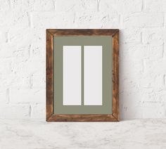 a white brick wall with a wooden frame on it