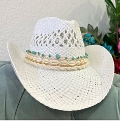 This coastal cowgirl hat has turquoise and gold details with shells. A coastal cowgirls dream! All hats are around 22-24 inches inside but come with an adjustable string that can tighten the hat inside. Check out my Instagram @delisico *PLEASE MESSAGE ME IF YOU NEED FOR A SPECIFIC DATE. BIRTHDAY, CONCERT, EVENT* Luxury Turquoise Hats For Party, Coastal Cowboy Hat, Turquoise Hat For Summer Western-themed Events, Coastal Cowgirl Beaded Hat, Turquoise Country Style Beach Hat, Turquoise Brimmed Hat For Festivals, Blue Cowgirl Hat, Sailng Hat Turquoise, Turquoise Western Beach Hat