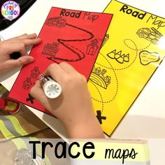 a child's hand writing on a piece of paper with the words road map