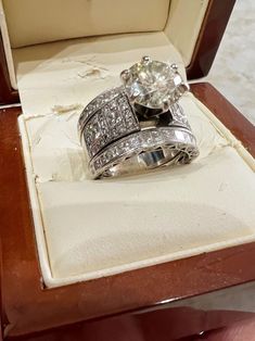 two wedding rings sitting on top of a wooden box