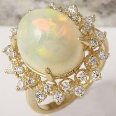 6.90 Carats Natural Impressive Ethiopian Opal and Diamond 14K Solid Yellow Gold Ring Suggested Replacement Value: $6,800.00 Total Natural Opal Weight is: Approx. 6.00 Carats Opal Measures: Approx. 15.38 x 12.07mm The head of the ring measures: Approx. 21.14 x 20.63mm Total Natural Round Diamonds Weight: Approx. 0.90 Carat (color G-H / Clarity SI1-SI2) Ring total weight: Approx. 5.9 grams Disclaimer: all weights, measurements and colors are approximate and may vary slightly from the listed dimens Formal White Diamond Gemstone Ring, Formal Multi-stone Diamond Opal Ring, Formal Multi-stone Opal Ring With Diamonds, Luxury Oval Opal Ring For Anniversary, Formal Opal Ring, Elegant Yellow Gold Opal Ring For Formal Occasions, Elegant White Cluster Ring Gia Certified, Elegant White Gia Certified Cluster Ring, Luxury Oval Opal Ring With 17 Jewels