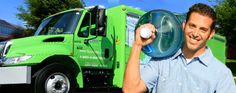 a man holding a ball in front of a green truck