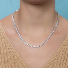 The Diamond Tennis Necklace is a piece of jewelry that features multiple diamonds set in a line or pattern, attached to a necklace. This specific necklace has a total carat weight of 20.00 carats. The diamonds are set in a 3-prong setting, which is a popular choice for displaying the diamonds in a way that minimizes the amount of metal around the diamonds, giving them a more open and airy appearance. The diamonds are 4.00 mm in size and the necklace is made of 14K gold, which is a popular type o Luxury Tennis Necklace With Vvs Clarity As A Gift, Luxury Women's Tennis Necklace With Single Cut Diamonds, Luxury Fine Jewelry Cubic Zirconia Tennis Necklace, Luxury Diamond Tennis Necklace For Formal Occasions, Luxury Round Single Strand Tennis Necklace, Luxury White Round Tennis Necklace, Luxury White Tennis Necklace For Formal Occasions, Luxury Iced Out Classic Tennis Necklace, Luxury Pave Setting Tennis Necklace For Formal Occasions