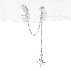 a star and moon necklace on a white background