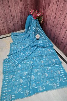 Mix elegance and beauty with a six-yard drape is the only leisurely collection of 2024 in light blue color with unparallel machine floral embroidery work on the body, pallu, and scallop border which is donned in the saree. With allover resham checks to bring out the elegance. Color: A shade of light blue color Technique: Amazing work of machine embroidery work done with a scallop border on the saree and resham checks work Fabric: Resham Kota