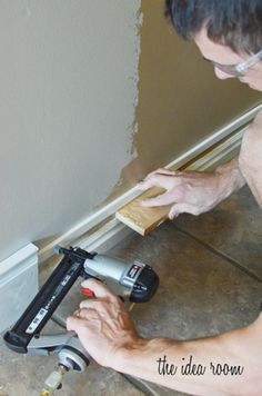 a man using a cordless drill to fix a tile floor in a home with the text molding panel trim etc on pinter