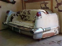 an old couch sitting in the corner of a room