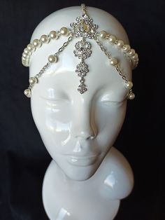 Looking for a stunning headpiece to complete your bridal look?  Check out our Great Gatsby-inspired headpiece, perfect for adding a touch of vintage glam to your hairstyle.  The bridal head chain is adjustable to fit any head size and is lightweight and comfortable to wear.  This headpiece will make you feel like a true goddess on your special day. Order now and add some sparkle to your bridal look! READY to SHIP It is weight about 50g Packaging: It is carefully shipped in a beautiful organza pouch with drawstring, bubble wrapped and well protected. It is also possible to order slave-bracelet in the same design as a set for creating ideal look just contact me.  More tikka here https://www.etsy.com/your/shops/JewelryFashionArt/tools/listings/section:19479022,view:table,stats:true Welcome to Hair Chain For Bride, 1920s Pearl Headpiece, Chain Hair Piece, 1920s Fashion Headpiece, Luxury Cream Headpieces For Events, Cool Headpieces, Cool Head Pieces, Head Jewelry Headpieces, Burlesque Jewelry