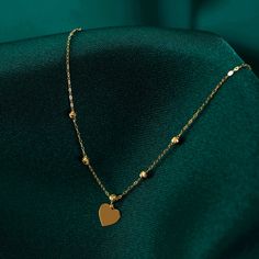 Introducing our stunning 14k Gold Beaded Heart Necklace, a timeless piece that oozes elegance and charm. Handcrafted with utmost care, this dainty necklace features delicate beads intricately arranged to form a captivating heart pendant. The use of high-quality 14k gold adds a touch of opulence and sophistication to this accessory, making it perfect for special occasions or daily wear. Whether you are looking to treat yourself or searching for a thoughtful gift, this necklace is sure to make hea Elegant Gold Necklaces With Heart Beads, Elegant Heart Necklace With Delicate Chain, Elegant Rose Gold Jewelry With Heart Beads, Delicate Chain Heart Necklace In 14k Gold Filled, Elegant Heart Necklace With Delicate Chain As A Gift, Dainty Pendant Necklace With Beaded Chain, Elegant Round Bead Necklaces As A Gift For Her, Elegant 14k Gold Filled Heart Pendant Jewelry, Elegant Necklace With Round Beads As Gift For Her