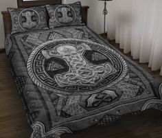 a bed covered in a black and white comforter