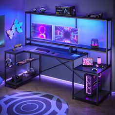 a computer desk with two monitors on top of it in front of a purple wall