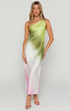 a woman in a white and green dress with one shoulder draped over her body, posing for