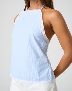 This blouse features a high neck halter design with a detailed tie back for an adjustable fit to your tailored desire. Chic Stretch Top With Tie Back, Elegant Stretch Halter Top For Day Out, Chic Halter Neck Top For Beach, Chic Halter Neck Beach Tops, Elegant Backless Top With Tie Back, Elegant Halter Neck Top With Tie Back, Chic High Neck Cotton Tops, Chic Cotton Camisole With Tie Back, Elegant Halter Neck Crop Top For Day Out