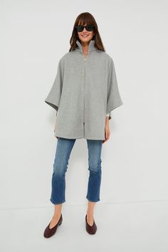 The Grey Full Zip Huntington Cape is a closet must-have for the cold-weather months. The oversized silhouette makes this the perfect layering piece, and the zip closure allows this to be worn on its own or over a button-down. With a wool blend, you are sure to be comfy and cozy in this stylish look- pair with denim and loafers or with a dress and boots for an absolutely elegant outfit. Ribbed stand collar Long poncho sleeves Tonal button at inside of sleeve Gold-tone front zip closure Cape silho Wool Funnel Neck Outerwear For Work, Wool Outerwear With Funnel Neck For Work, Funnel Neck Wool Outerwear For Work, Cashmere Cape For Winter, Wool Outerwear With Funnel Neck For Fall, Wool Cape For Cold Weather, Oversized Cashmere Outerwear For Winter, Funnel Neck Cashmere Outerwear For Fall, Fall Cashmere Outerwear With Funnel Neck