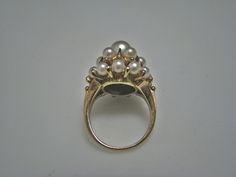 "For Sale is: (1) H077 Stunning Coctail (19) Pearl Ring in 14k Yellow Gold Please Read ENTIRE DESCRIPTION BEFORE PURCHASING This beautiful ring features cocktail ring with multiple (19) pearls in different size. Ring stamped 14k and it is size 5.5 This is a very elegant ring! Cosmetic Condition: This ring is in good condition. A few minor scratches due to age. AS SEEN IN PICTURE: Specifications: *14K Yellow Gold *Cocktail Style *Pearls (12) are approx. 3.4 mm (at the bottom of the ring) *Pearls Luxury Yellow Gold Timeless Pearl Ring, Yellow Gold Multi-stone Rings For Party, Classic Marquise Cluster Ring Stamped 14k, White Gold Prong Set Evening Ring, White Gold Rings With Prong Setting For Evening, Estate Oval Rings For Formal Occasions, Multi-stone Party Rings, Fine Jewelry Style, Gold Cluster Pearl Ring For Formal Occasions, Estate Style Oval Rings For Formal Occasions