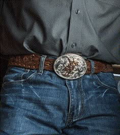 We love a classic beauty. This American Beauty Bull Rider Belt Buckle is as classic western as you can get. It is silver-finished and oval-shaped with filigree etchings. It holds a bull rider in the center that is gold-finished. It shines like a full moon in the night sky! Standard 1.5 inch belt swivel. Dimensions: Width 3.976000 Height 3.032000 Length 0.201000 Materials: 99.9% fine silver and 24K yellow gold plated over a brass base. Paint. Montana Armor to help prevent tarnish. Montana Silvers Cowboy Belt Buckle Aesthetic, Classic Concho Belt Buckles For Rodeo, Western Engraved Jewelry For Rodeo, Classic Hand Tooled Silver Belt Buckles, Classic Silver Hand-tooled Belt Buckle, Western Engraved Belt Buckles For Formal Wear, Western Style Engraved Jewelry For Rodeo, Vintage Engraved Belt Buckles For Rodeo, Western Concho Belt Buckles For Western-themed Events