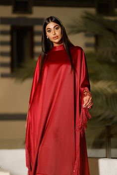 Featuring: High-neck Tie-wrap back closure. Silk fringe Satin fabric Butterfly sleeve caftan Luxurious fringe sleeves and hem Free size Fabric:Fringes - Silk.Bodice Fabric - Satin.Color: BurgundyBrand: Unmatched BYU Size: Free size. (Fits between size 2 US up to size 20 US).Length: 47 inches.This caftan is available in multiple colors Elegant Long Sleeve Kaftan With Tassels, Party Dress With Tassels For Eid, Party Dresses With Tassels For Eid, Tassel Dress For Eid Party, Long Sleeve Kaftan With Back Tassel Tie-up, Red Long-sleeved Kaftan For Party, Embroidered Long Sleeve Purple Kaftan, Red Silk Maxi-length Kaftan, Red Bohemian V-neck Kaftan