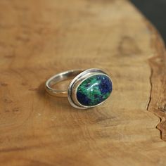 This is the perfect East-West Oval Ring and this Azurite Malachite is so gorgeous, revealing the classic blue of Lapis Lazuli and green of Malachite. The 10X14mm stone rests perfectly in this east west oval configuration. Simple and perfect with just an edge of .925 Sterling Silver. Wear this Azurite Malachite Statement Ring alone or on a hand full of rings. All traditional Silversmithing is done in my Baltimore MD studio. Azurite Malachite 10X14mm Ring top 14X18mm .925 Sterling Silver All tradi Hand Full Of Rings, Silversmith Rings, Pink Opal Ring, Malachite Ring, Vintage Silver Jewelry, Purple Amethyst Ring, Malachite Rings, Purple Rings, Lapis Ring