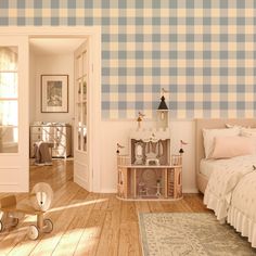 a bedroom with blue and white checkered wallpaper on the walls next to a bed