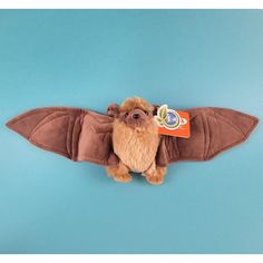 a stuffed animal with a toothbrush in it's mouth on a blue background