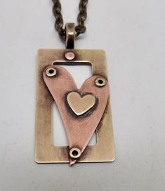 "Awesome mixed metal steampunk necklace . The size is 1 1/4\" by 3/4 \" and it has 24\" antique brass chain. I patina the body to give it a vintage look and the I sealed it to prevent tarnishing. All my jewelry come in a nice gift box." Jewelry With Rivets, Riveting Jewelry Ideas, Mixed Metal Pendants, Titanium Jewelry Handmade, Cold Connection Jewelry, Riveting Jewelry, Rivets Jewelry, Rivet Jewelry, Penny Jewelry