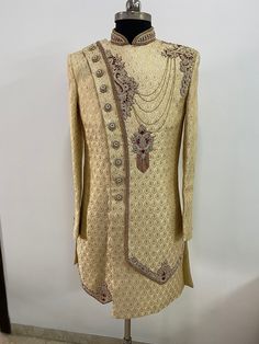 This is a Beige colour made to measure sherwani set. The red and golden embroidery on this sherwani looks elegant.it has mandarin collar, long sleeves,knee length, straight hem . This sherwani is all that you need to make an amazing first impression at a wedding or any event. Colour options available. Customisation available. . For any queries or customisation plz WhatsApp me on +918291343471. Red Kurta For Wedding, Red Wedding Kurta, Bollywood Style Nehru Jacket For Reception, Festive Nehru Jacket With Intricate Embroidery For Groom, Bollywood Sherwani With Intricate Embroidery For Groom, Embroidered Kundan Sherwani For Wedding, Bollywood Embroidered Traditional Groom Wear, Bollywood Embroidered Sherwani For Groom, Gold Kurta With Dupatta For Reception