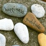 three rocks with the words happiness and grateful written on them