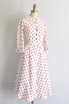 "Vintage 1950s cotton sundress. White with red polka dot print. V collar, darted bust and fold over long sleeves . Faux pockets in back. Nipped waist followed by a full skirt. Front button closure. State of garment | good, light overall wear and faint yellowing underarms, the inner collar and near hemline. Measurements ✂--- best fit | extra small bust | up to 37 \" shoulders | 15 \" shoulder to waist | 14\" sleeves | 16\" waist | 24 - snug 25\" hips | free total length (shoulder to hem) | 42 \" Polka Dot Long Sleeve Cotton Dress, Long Sleeve Polka Dot Cotton Dress, Vintage Polka Dot Long Sleeve Dresses, Vintage Long Sleeve Polka Dot Dress, Retro Polka Dot Dress For Daywear, Spring Polka Dot Collared Dresses, Retro Polka Dot Day Dresses, Vintage Polka Dot Dress For Daywear, 1950s Style White Cotton Dress