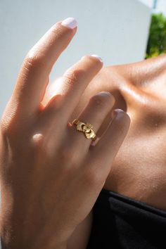 a woman wearing a gold ring on her left hand