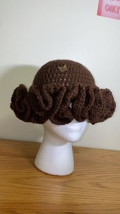 a crocheted hat on top of a white mannequin head