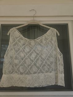 Seashell lace tank top. Would make a super cute beach cover-up! Dimensions:  Width: 23" Length: 18" To ensure a good fit, I recommend comparing these measurements to a tank top that fits you well. Sleeveless Lace Tank Top With Lace Patchwork, Sleeveless Lace Camisole With Lace Patchwork, Summer Cotton Lace Top, Sleeveless Lace Crop Top With Lace Trim, Casual Cotton Lace Top For Summer, Summer Cotton Lace Top With Lace Patchwork, Summer Lace Top With Lace Work, White Cotton Lace Top For Summer, Lace Patchwork Camisole Tank Top