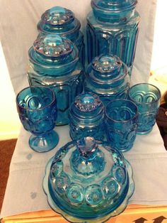 blue glass dishes and cups on a table