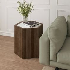 a living room with a couch, chair and table on the floor in front of a white wall