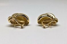 Estate Signed Henry Dankner 18k YG Solid Rope Twist Shell Omega Back Earrings Metal: 18k yellow gold (stamped) Weight: 23.8 grams Size: 25.50mm high x 17mm wide (at widest and highest points) Hallmarked: Dankner Copyright 18k Shell shaped swirl design with post and omega backs This is an estate piece in like new condition. Please see pictures for reference. Classic Gold Clip-on Earrings With Polished Finish, Yellow Gold Oval Clip-on Earrings With Polished Finish, Gold Earrings Stamped 14k Fine Jewelry, Luxury Gold Oval Clip-on Earrings, Yellow Gold Oval Clip-on Earrings For Anniversary, Luxury Polished Yellow Gold Clip-on Earrings, Tarnish-resistant Yellow Gold Round Clip-on Earrings, Tarnish Resistant Yellow Gold Round Clip-on Earrings, Tarnish Resistant Yellow Gold Clip-on Earrings