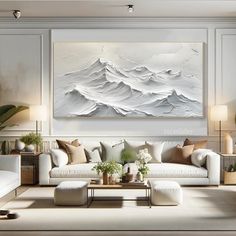 a living room with white furniture and paintings on the wall